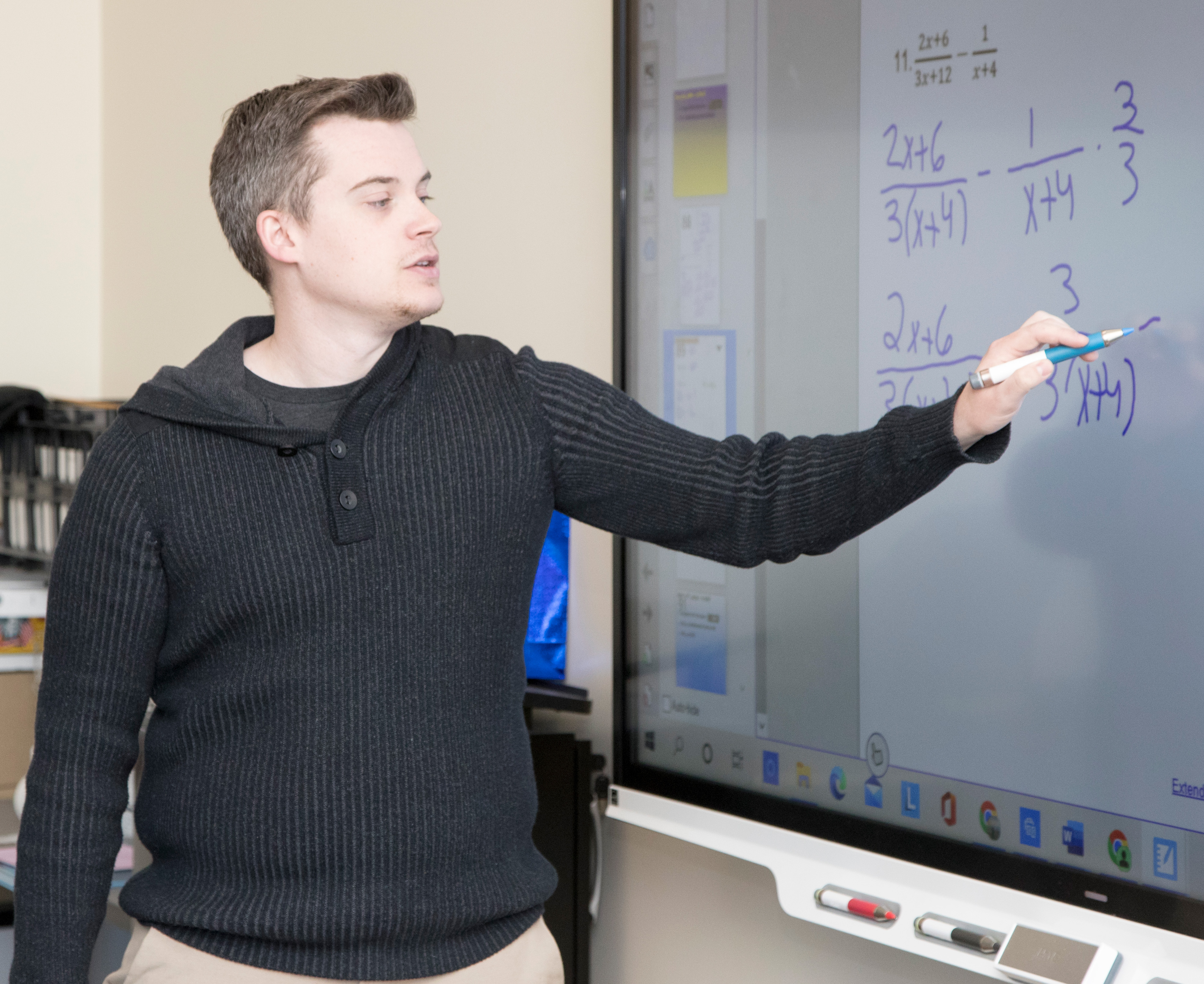Student completes equation on SMART board