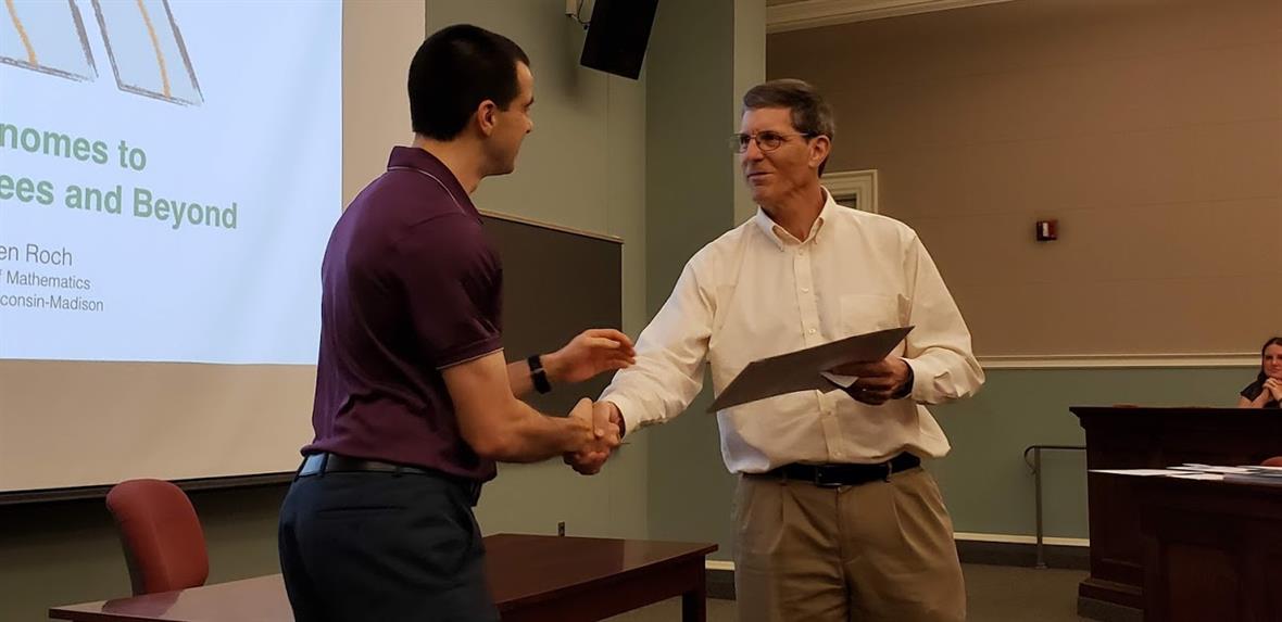 Nicholas Russell receives the Baxter-Sloyer Teaching Award from Dr. Braun